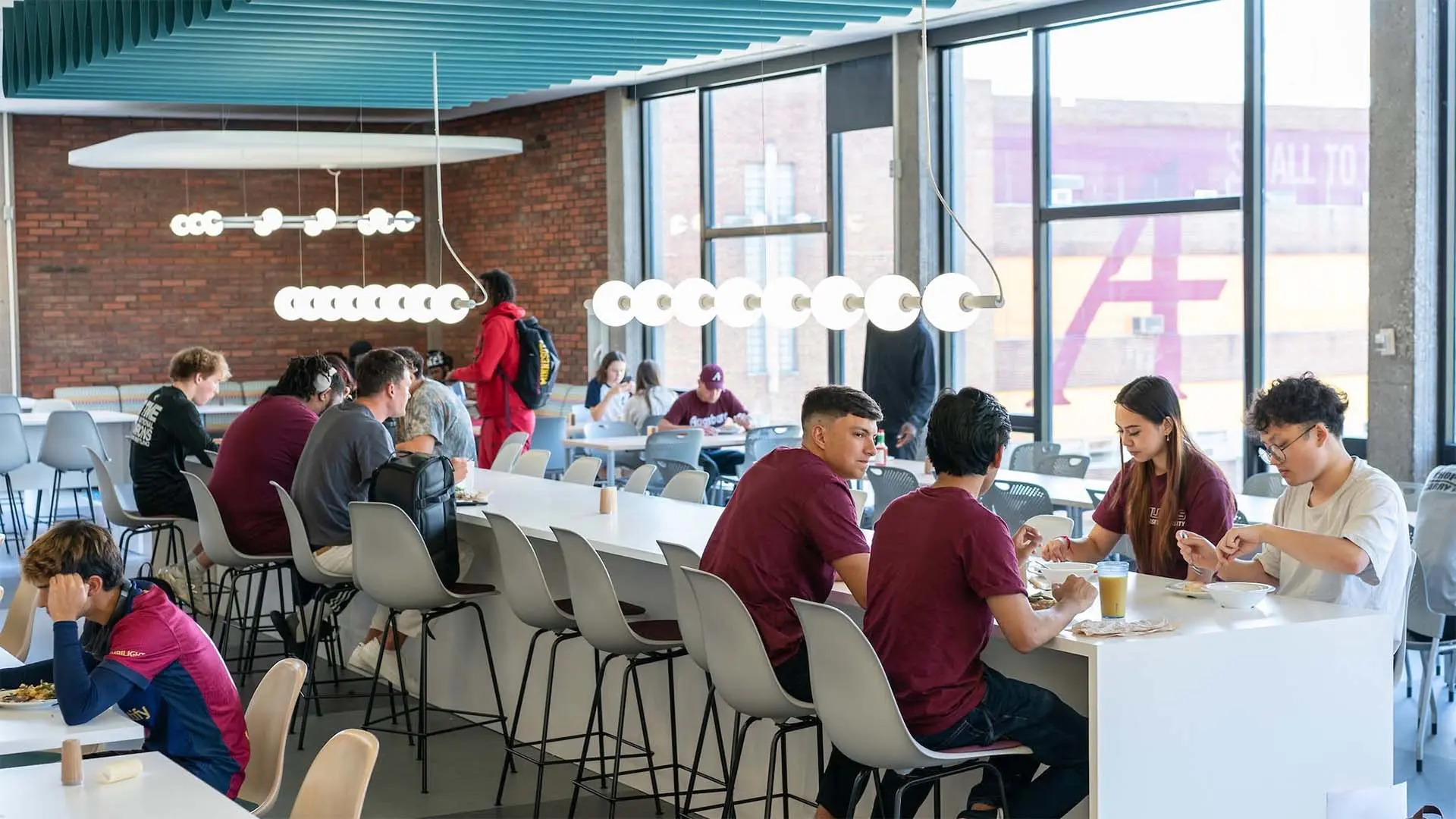 Students eat and socialize around communal tables in the Dining Commons.